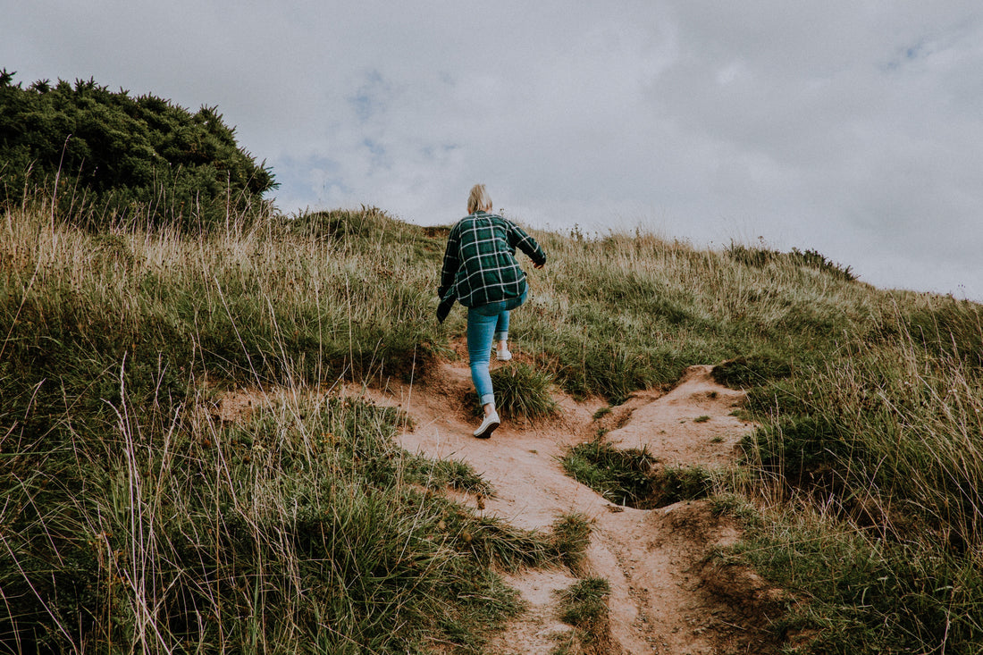 A woman is walking uphill