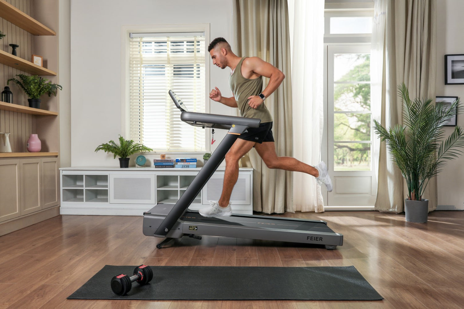 A man uses a Feier Star 100 with an incline and speed-adjustable treadmill at home